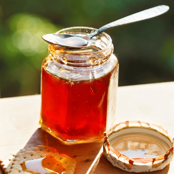 Jar of honey with spoon on top