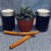 Mason jars on cloth filled with elderberry syrup