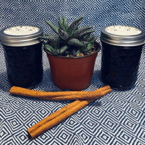Mason jars on cloth filled with elderberry syrup