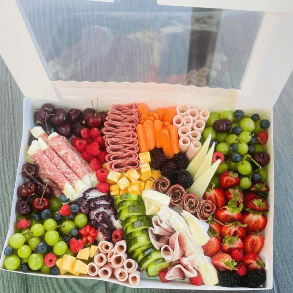 Party Box that contains assortment of meats, cheeses, fruits, and vegetables.