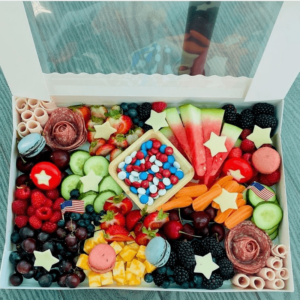 Party Box that contains assortment of meats, cheeses, fruits, and vegetables.